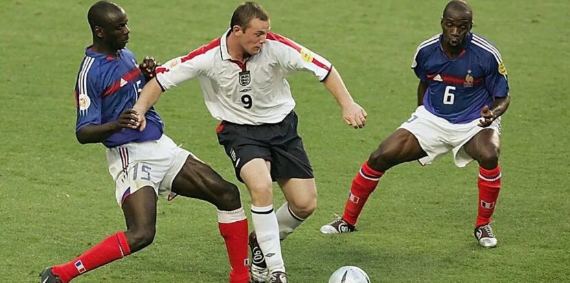 Wayne Rooney dikawal dua pemain Prancis saat laga panas Euro 2004